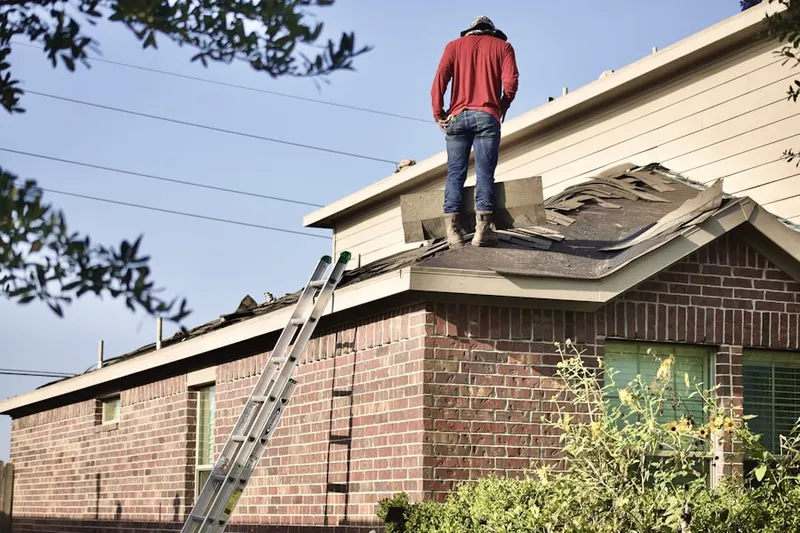 Professional roofer working on a residential roof in East Wenatchee